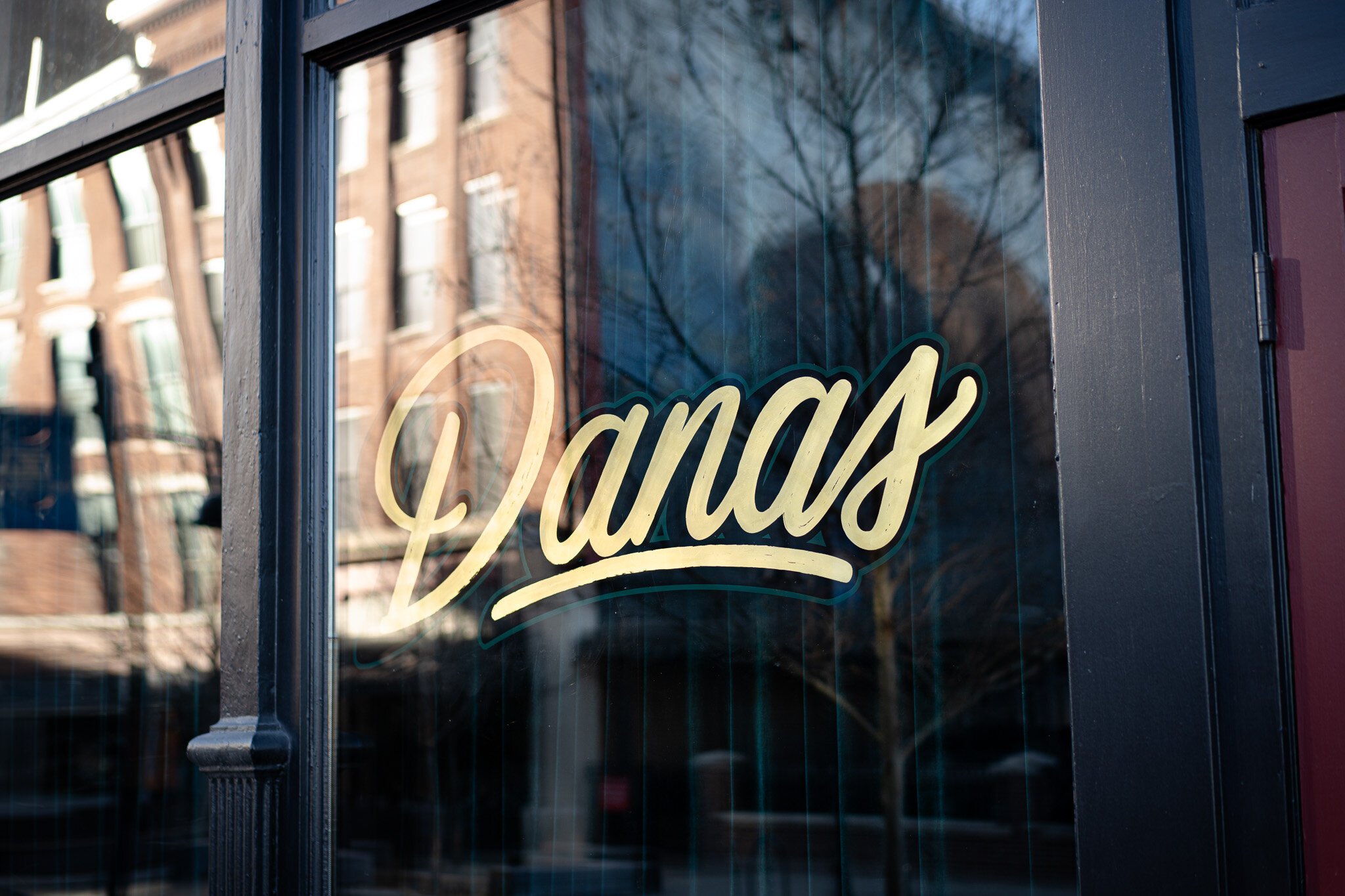 The Dana's logo painted by Justin Lim on the bar's front window.