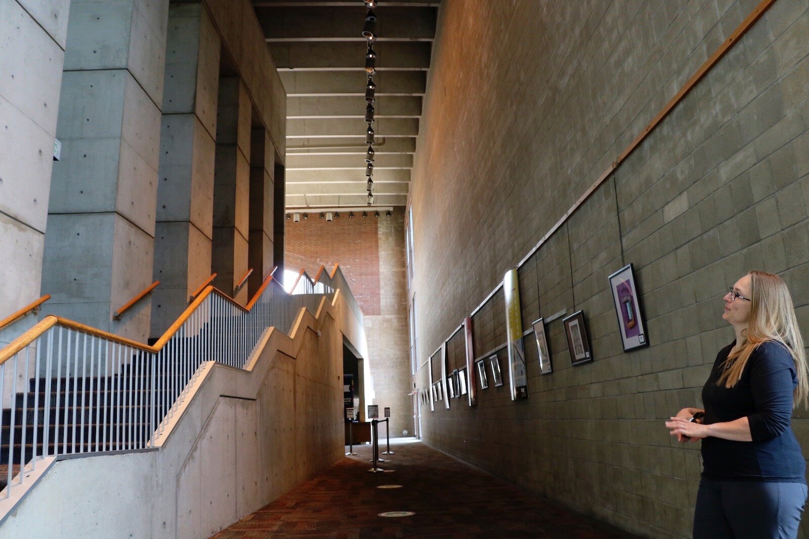 Miriam Morgan, Arts United Chief Operating Officer, shows the exterior of the concrete staircase that leads to the auditorium inside the Arts United Building. 