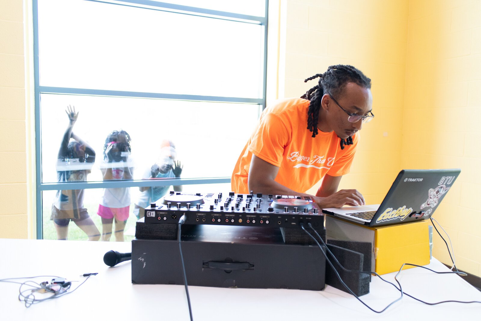 VP of Bigger Than Us Tyler Whitfield DJs during the Book Bag Giveaway at Renaissance Pointe YMCA, 2323 Bowser Ave.