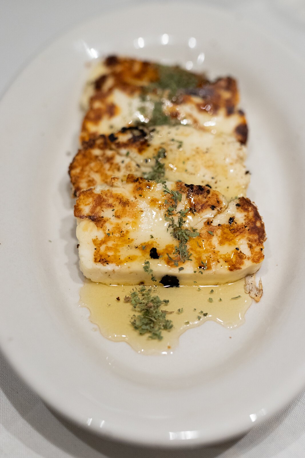 Deema pairs their halloumi with honey and dried mint leaves, which gives the dish a salty-sweet vibe that’s rounded out with a subtle earthiness from the mint—reminiscent of herbal tea.