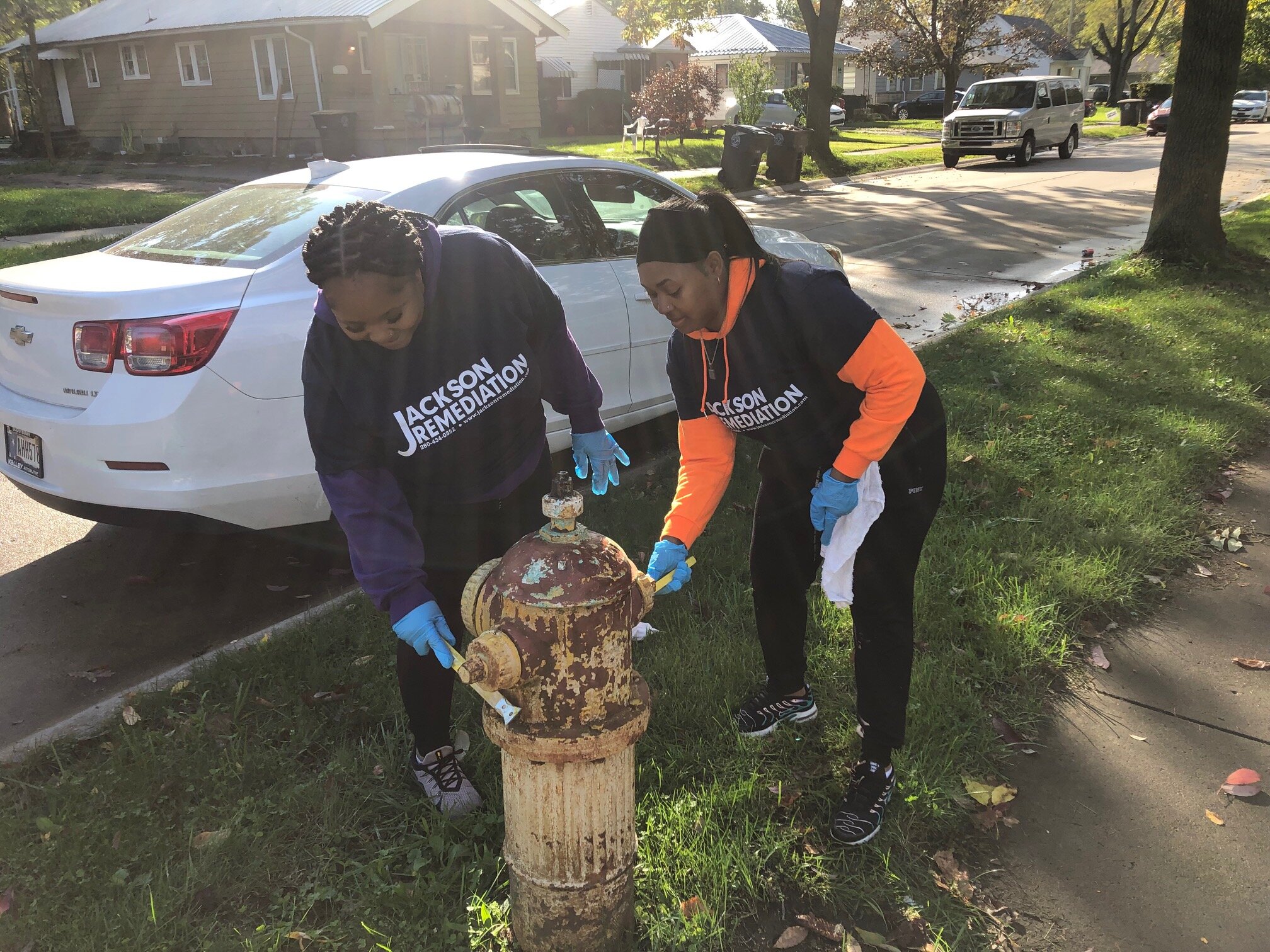 NeighborLink volunteers collaborate on service projects in Fort Wayne neighborhoods, like painting fire hydrants.