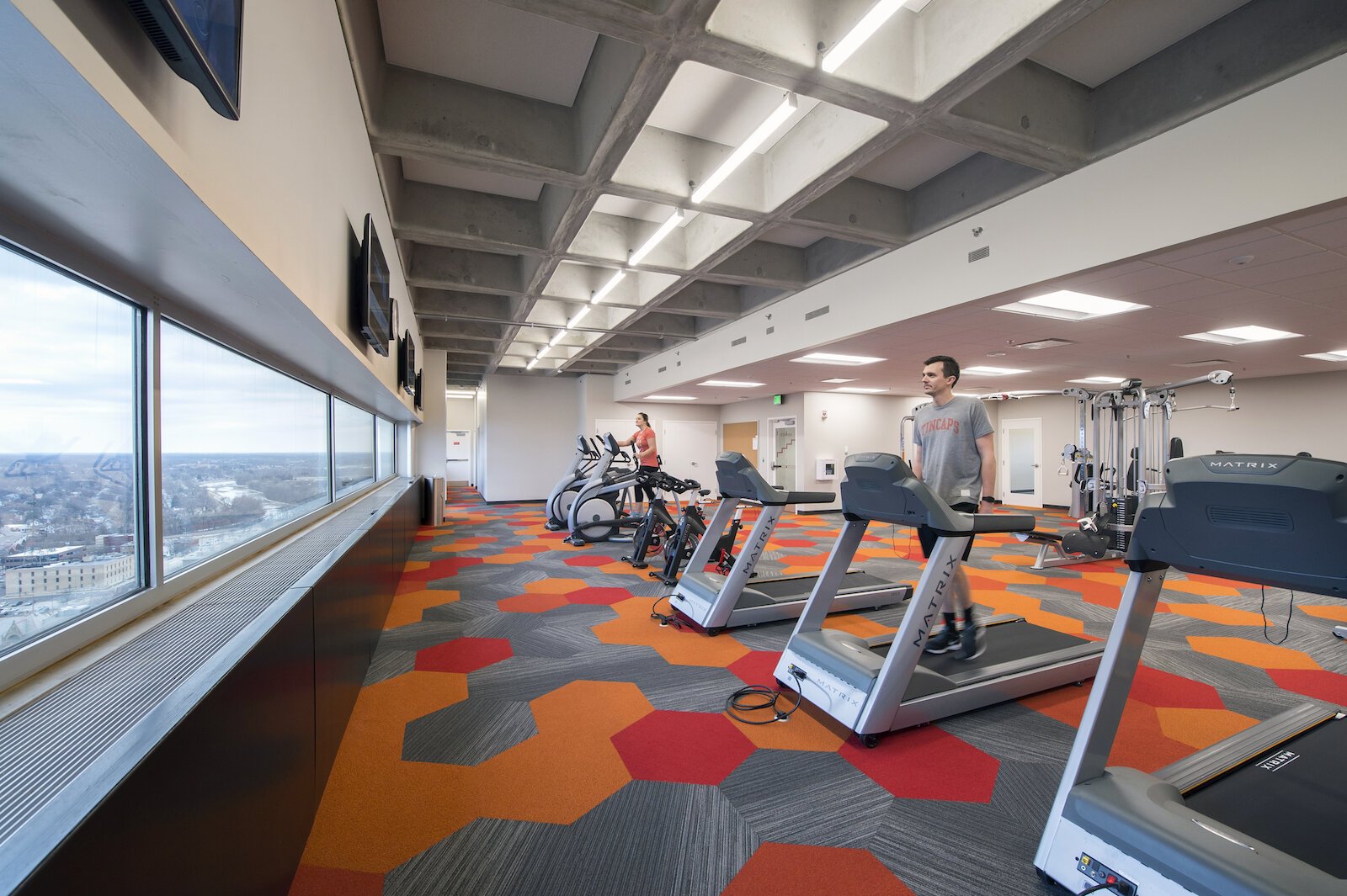 At Indiana Michigan Power Center’s Corporate Headquarters in Fort Wayne, Design Collaborative designed a fitness studio for employees that overlooks the outdoors.