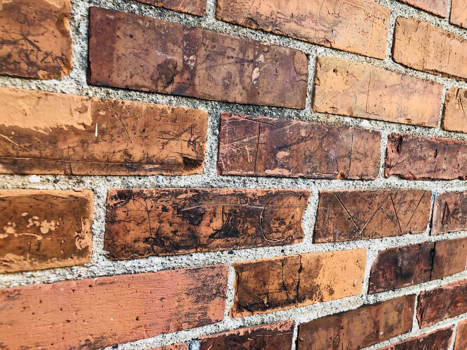 Names and letters carved into the exterior brick at the former Puckerbrush Schoolhouse.