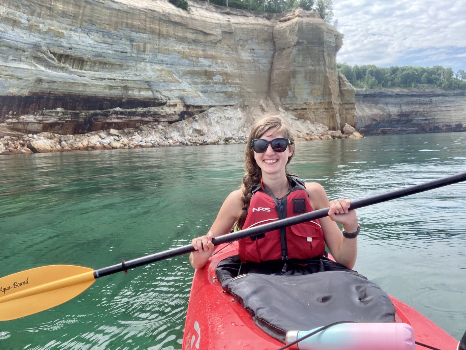 Full-time traveler Alexys Esslinger kayaks in Pictured Rocks National Lakeshore in Michigan.