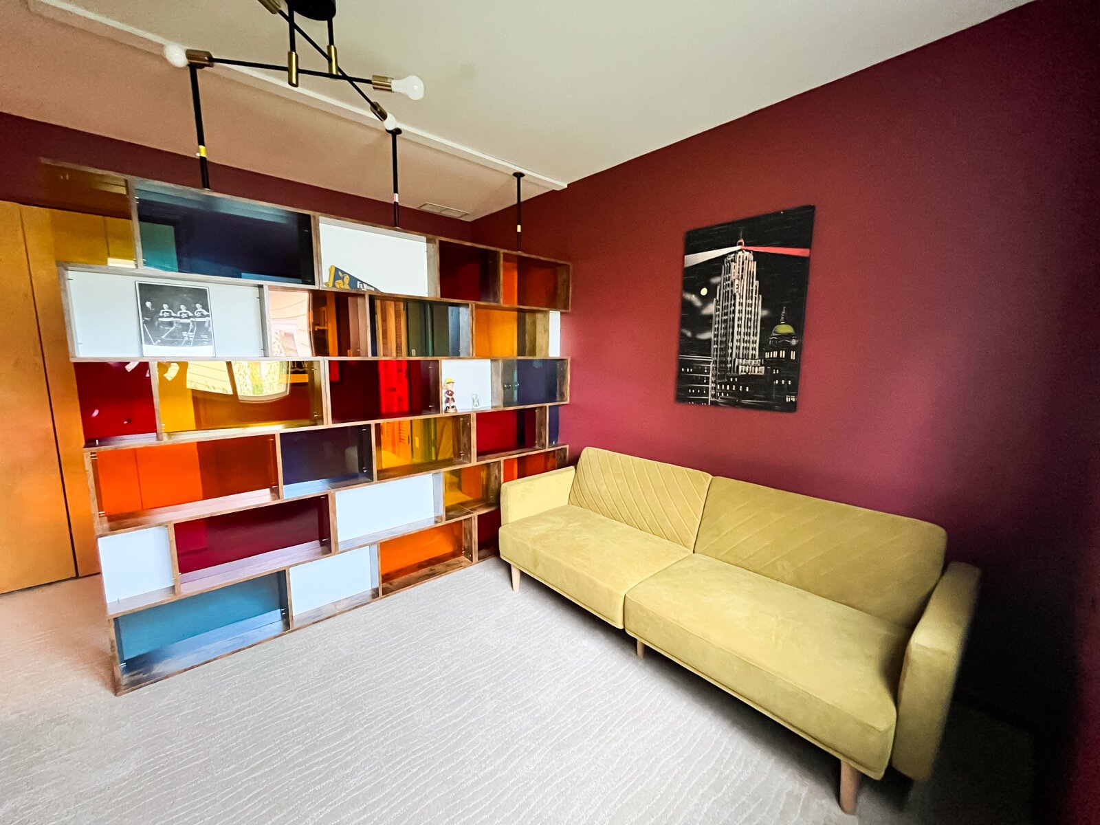 The office area features a colorful room dividing wall.