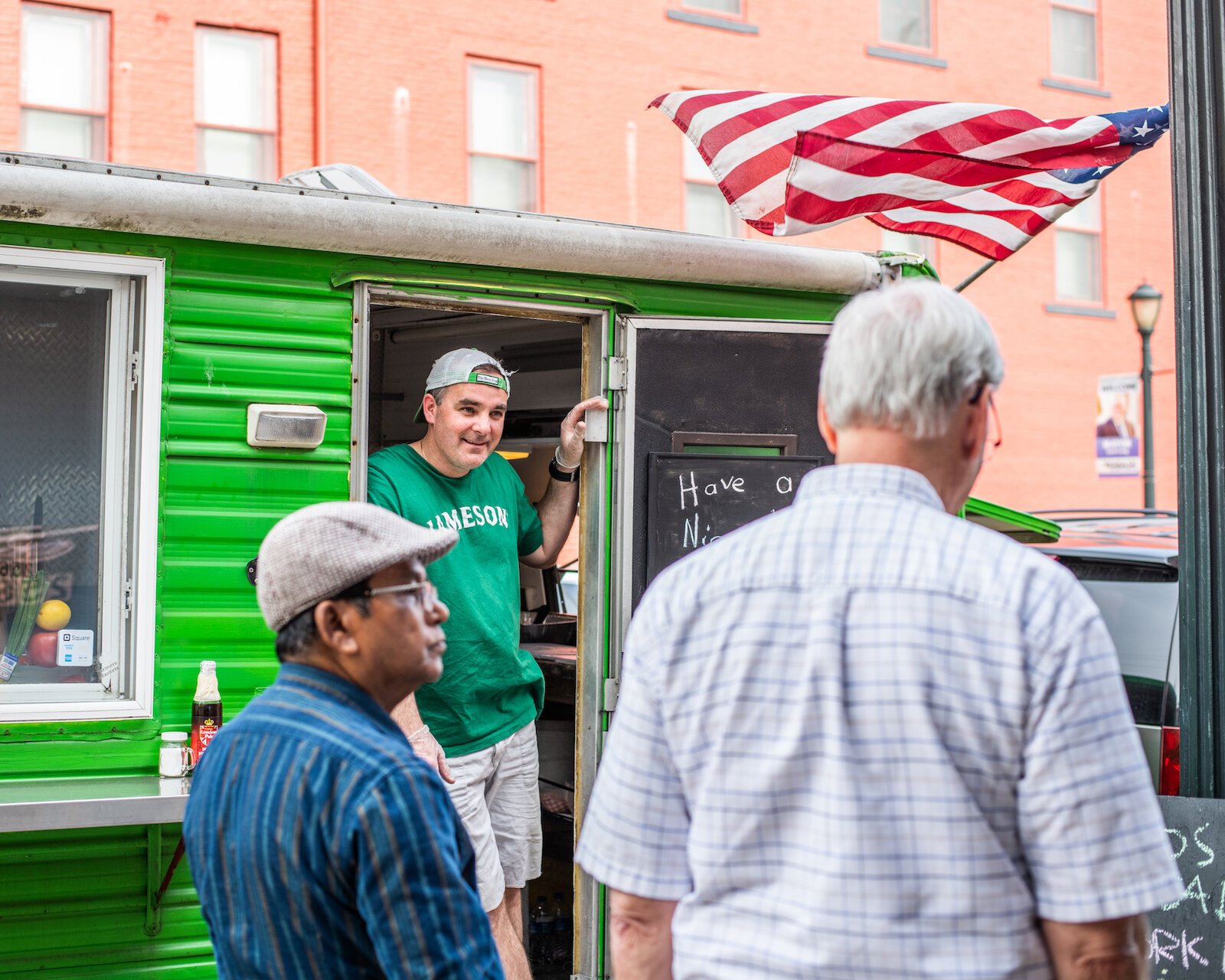 Emmett McIlvenny, owner of Emmett’s Paddy Wagon, talks with customers outside his food truck.