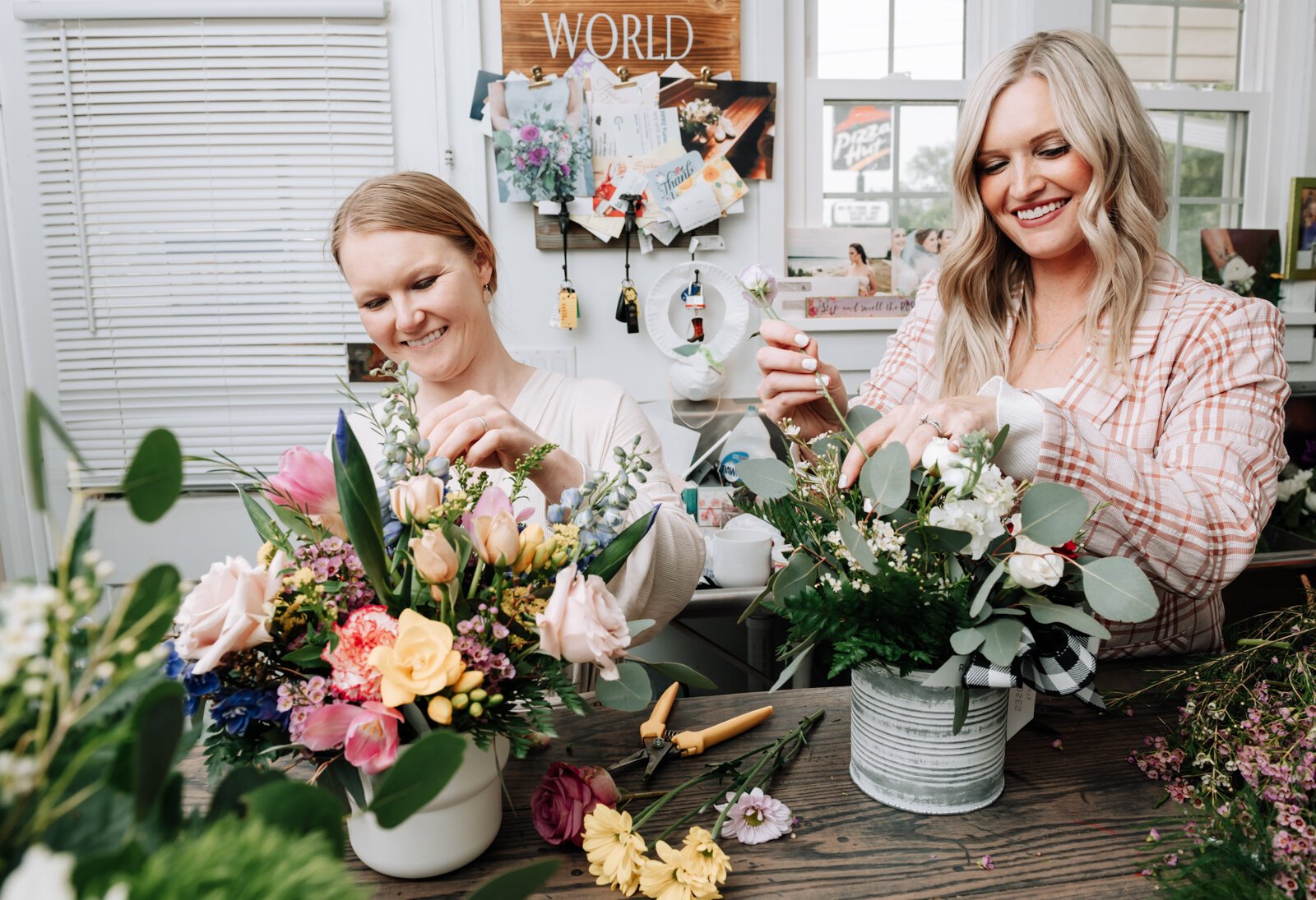 Owners Josi Cripe Lambert, left, and sister Jentri Cripe Lengerich work on creating a flower arrangement at Rhinestones and Roses Flowers and Boutique, 302 W State Rd 114.