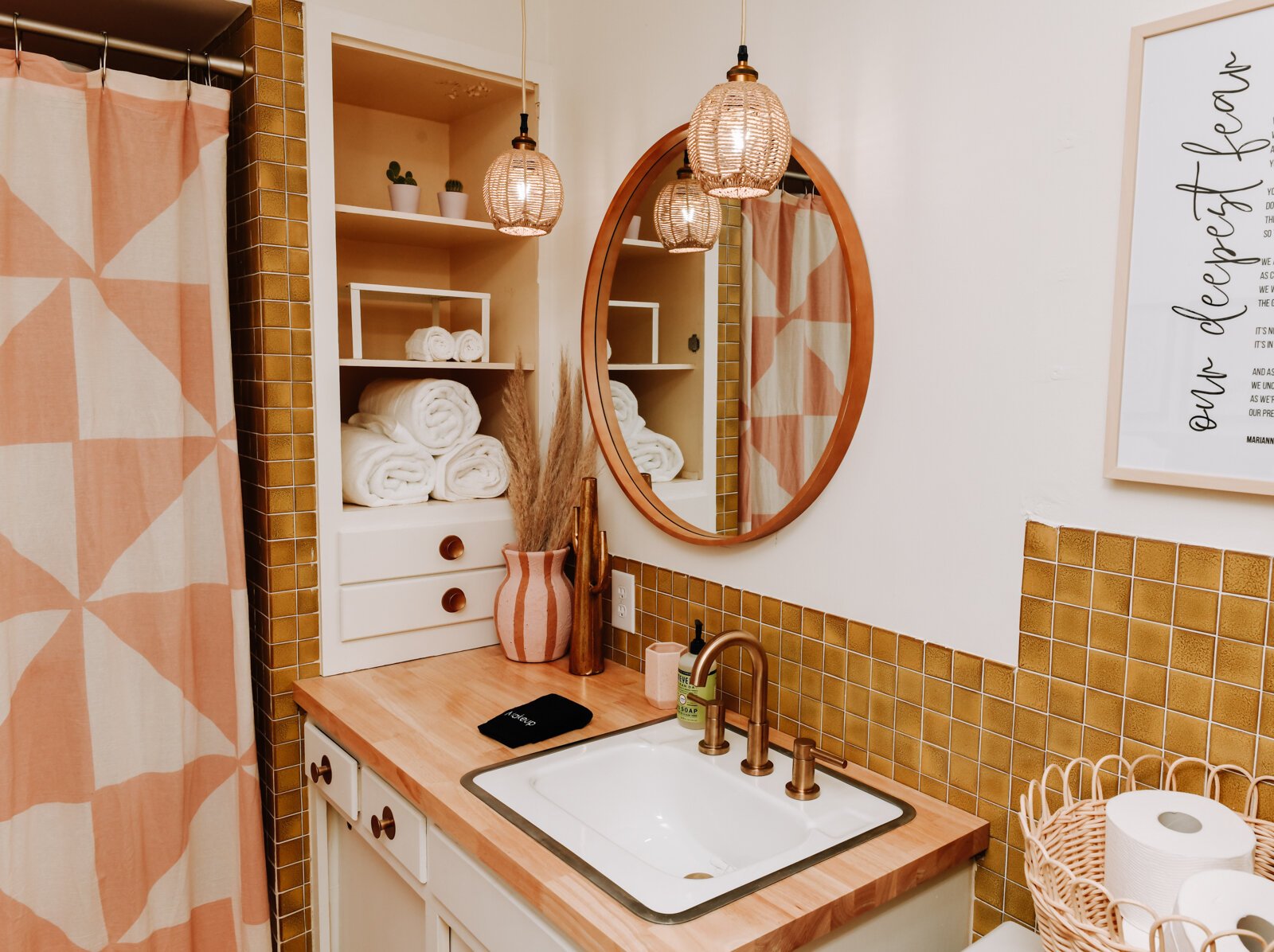 The master bathroom features a gold and pink color scheme.