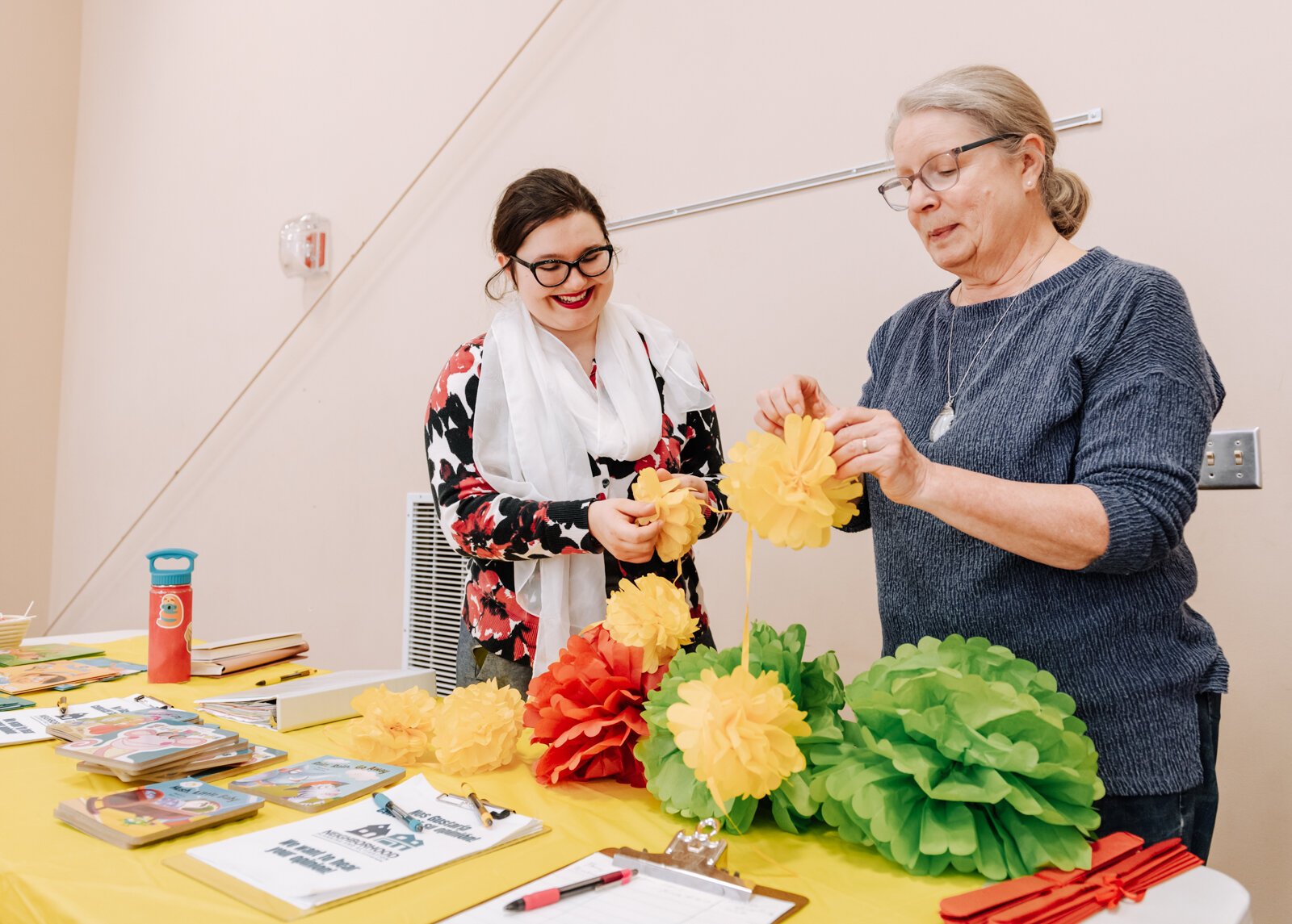 Bernadette Fellows, Community Engagement Planner with the City of Fort Wayne left, and Margaret Machlan, President of Harvester Neighborhood Association work together to decorate a table during the Fall Fest event at Harvester Missionary Church.