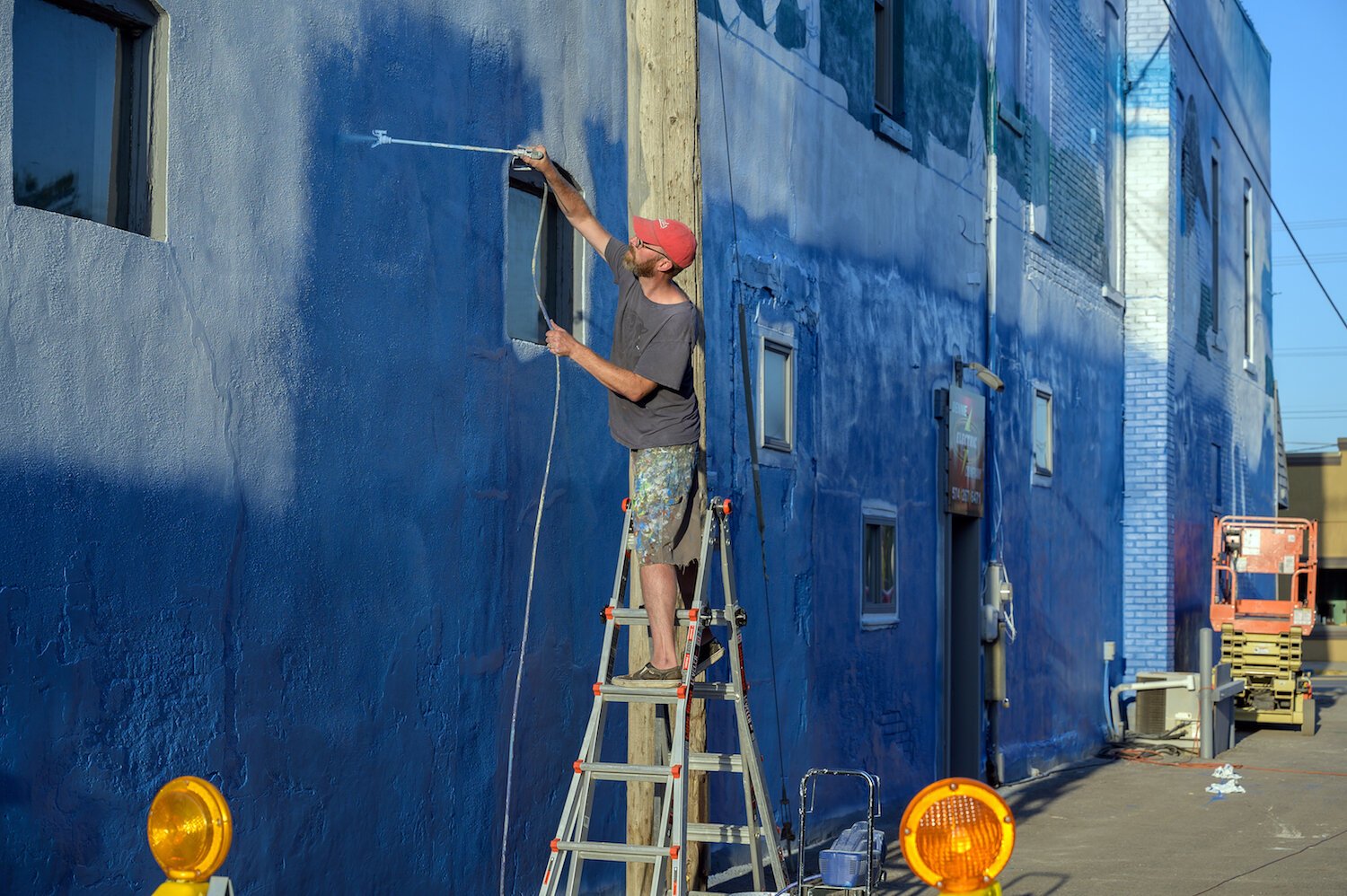 Tim Parsley works on a mural in downtown Warsaw.