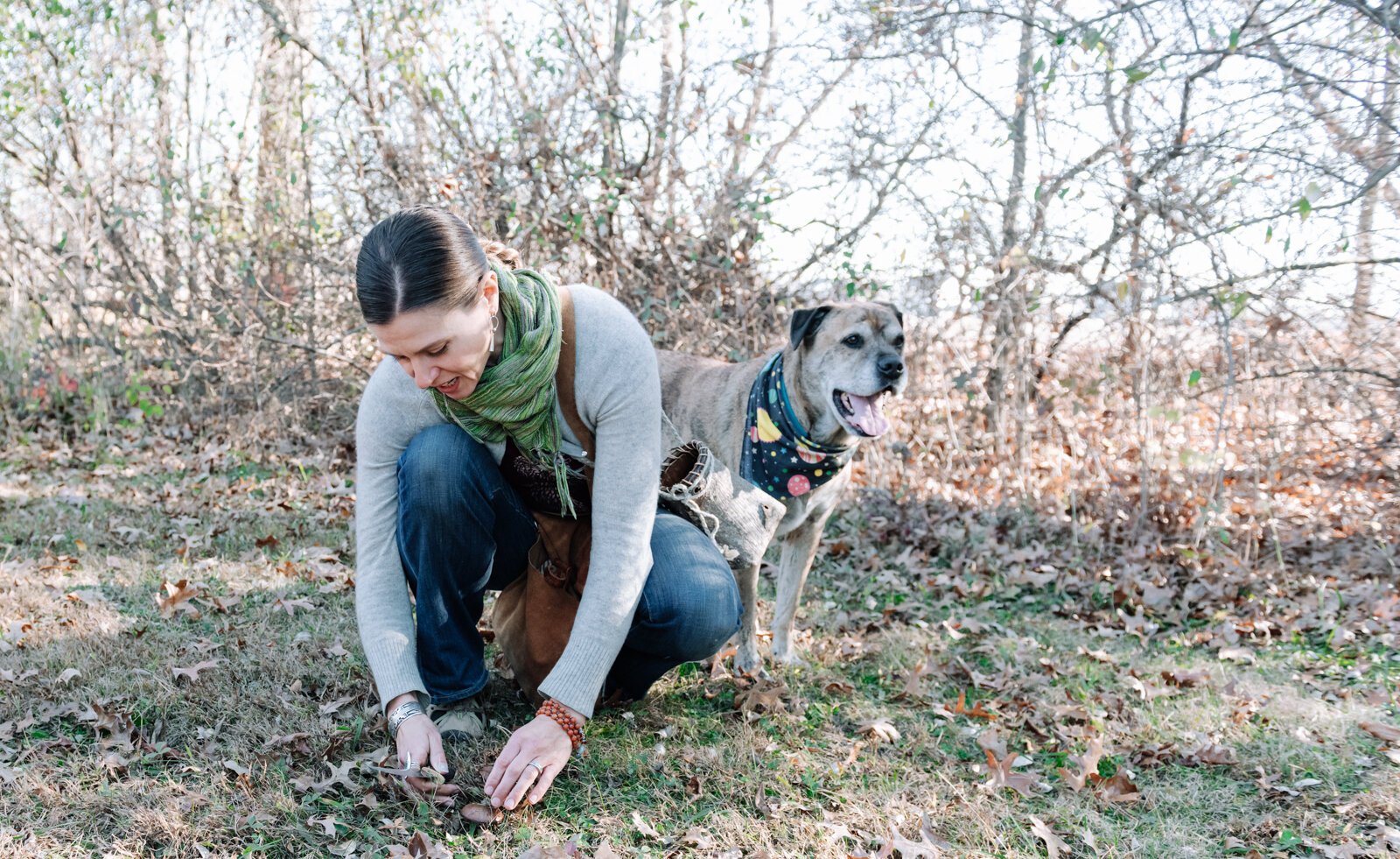 Claudia Hedeen of the Miami Tribe of Oklahoma, forages a mushroom from the genus Suillus with her dog Hobbes on Miami tribal property in Fort Wayne.