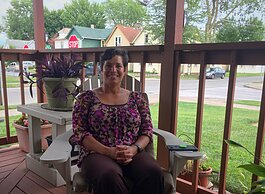 Rebecca Ridley enjoys her front porch in the Renaissance Pointe neighborhood.