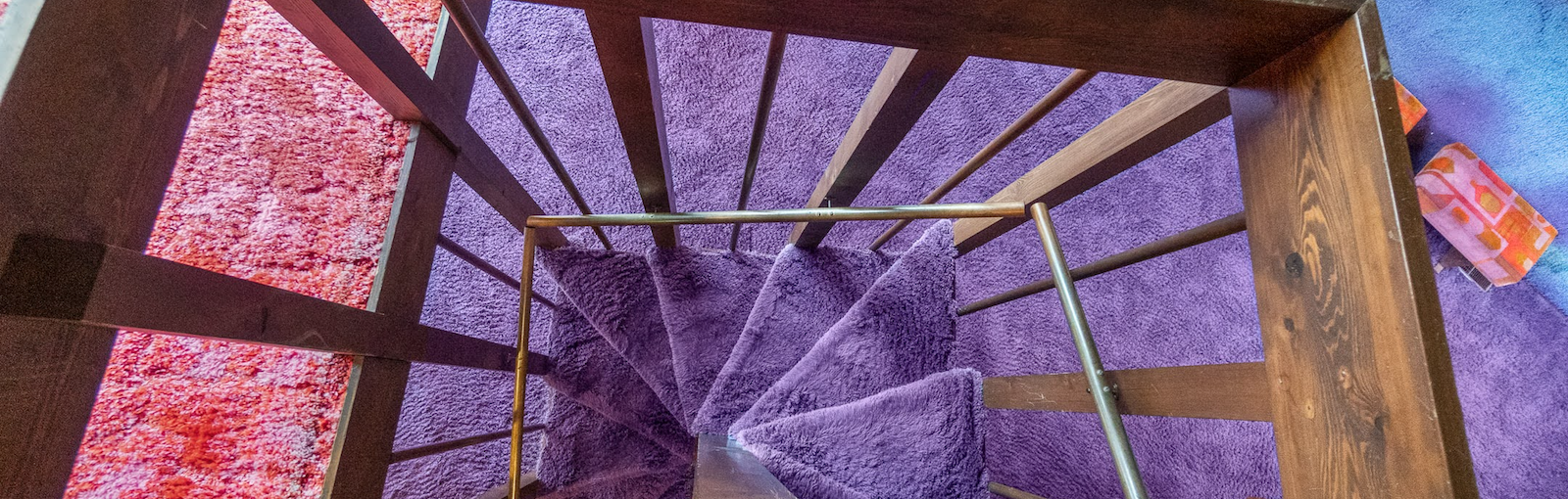 The psychedelic staircase of a viral 1970s time capsule home in Fort Wayne that's going from shag to chic.