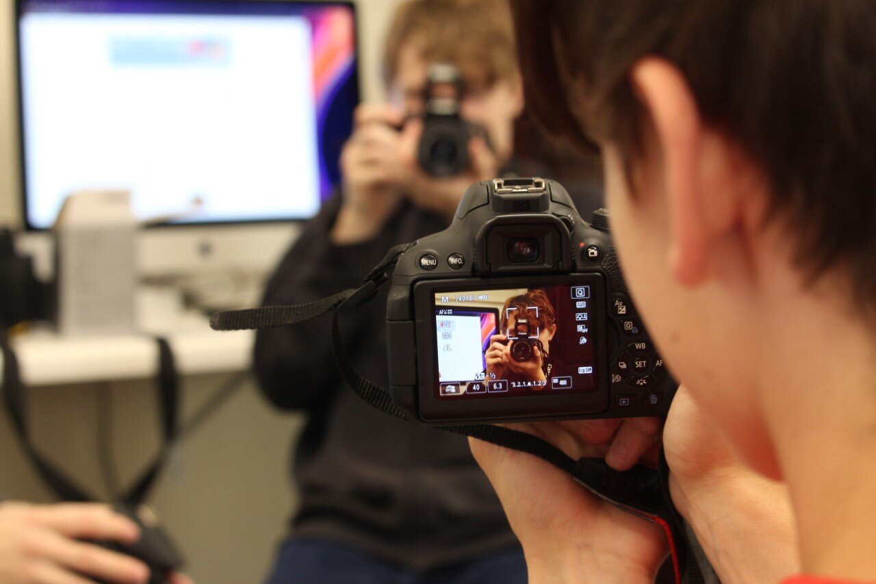 First year students working with cameras in class.