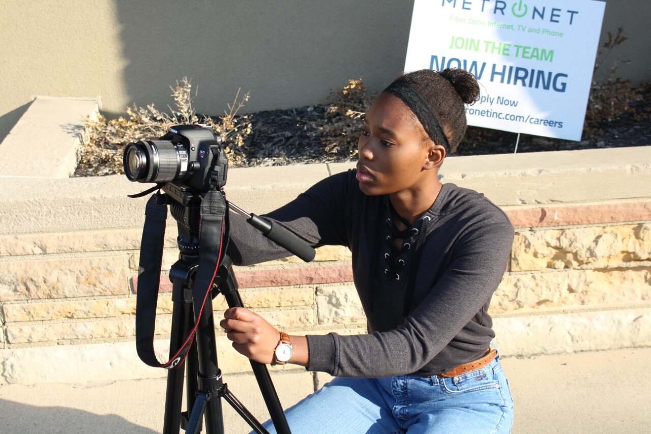 First-year student Joyce Harvey uses a camera and tripod to take a photo for the Basic Photography class.