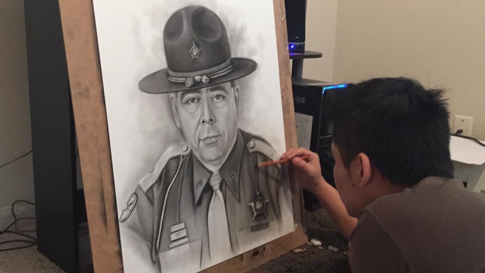 Parkview Police Officer Htoo Doh works on an art piece.