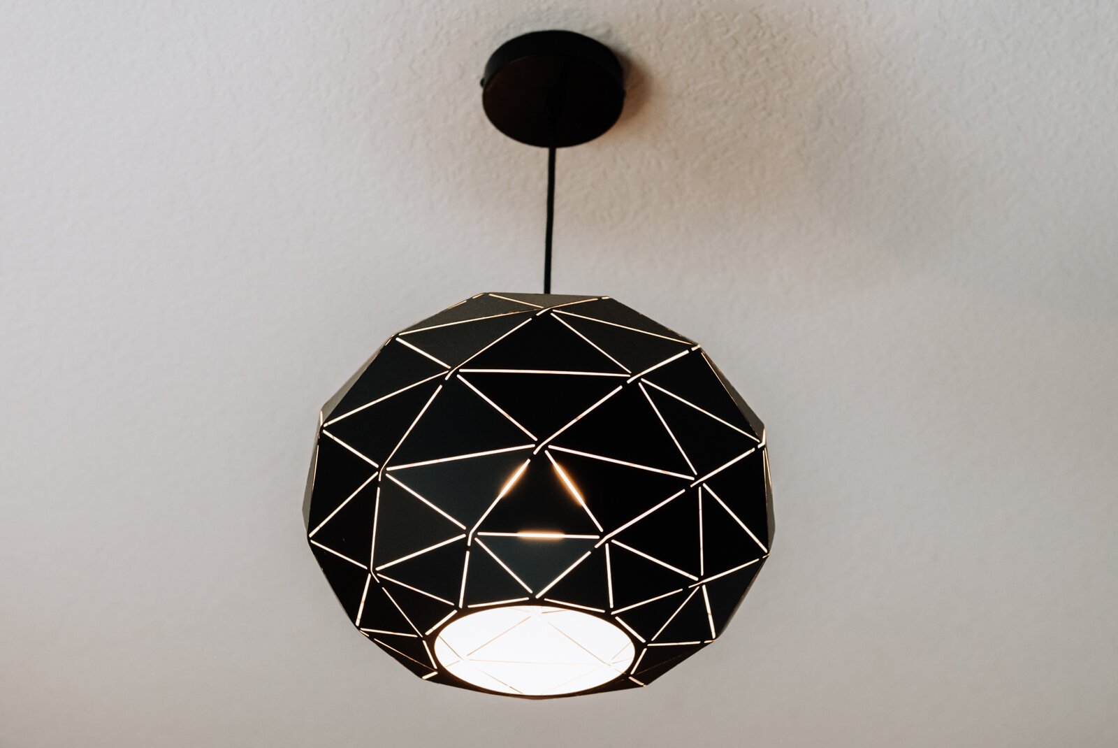A geometric bedroom light feature in the back bedroom on the bottom floor.