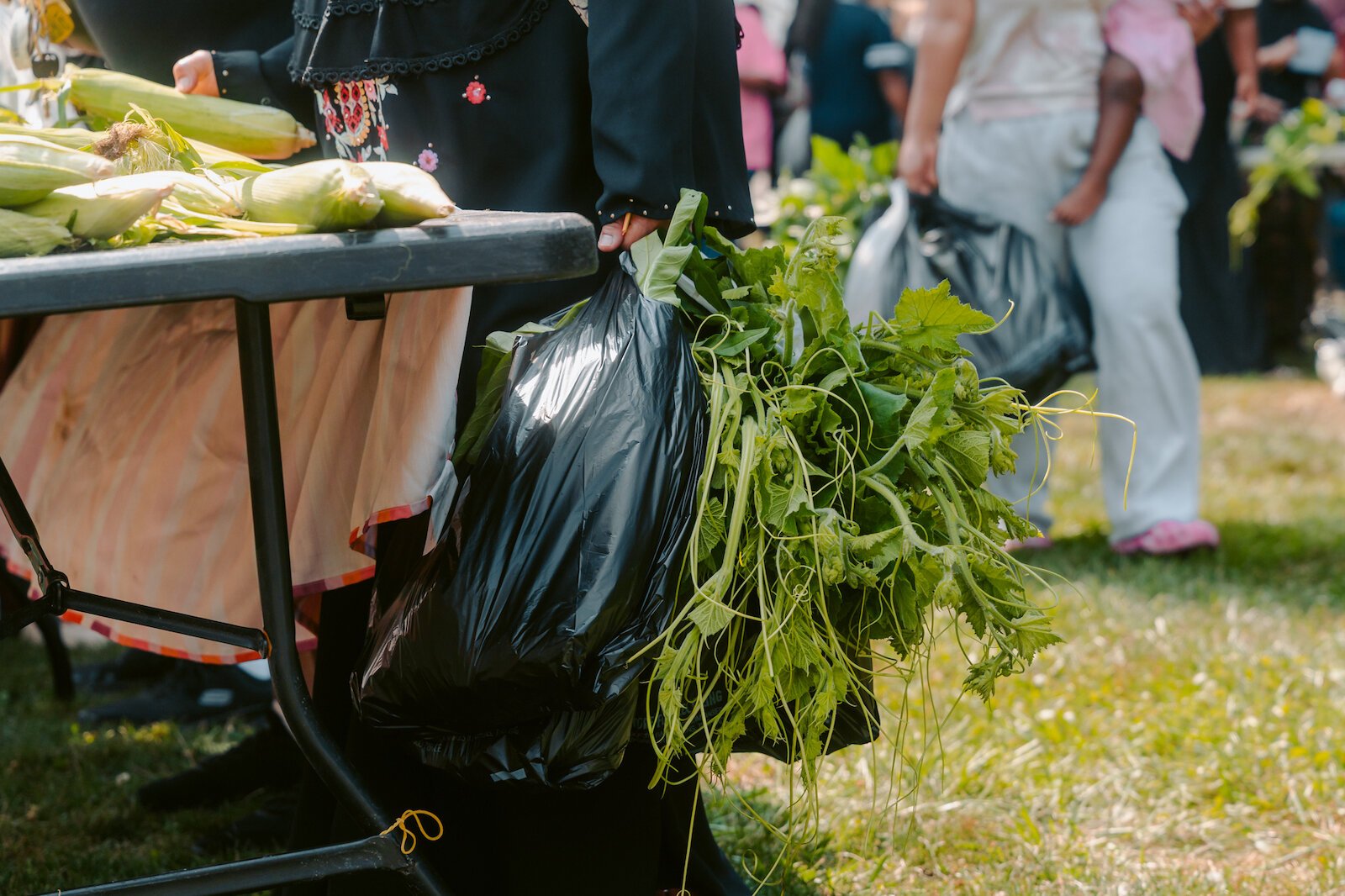 Market attendees shop for fresh produce, grown by local farmers.