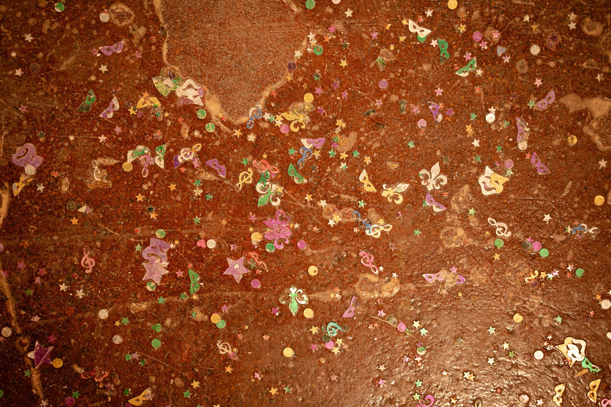 Mardi Gras confetti in the floor at Night Train, a ode to the days of Bourbon Street Hideaway's time in the space.