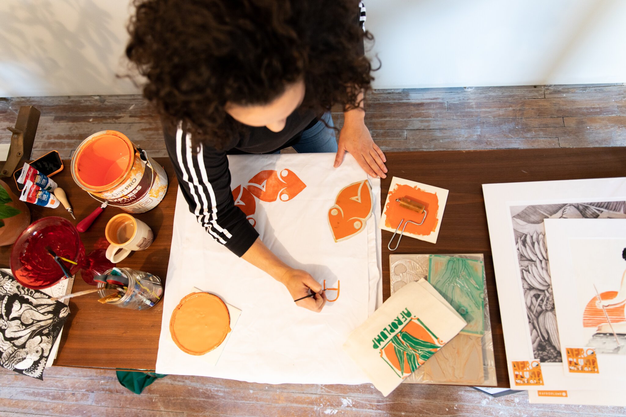 Fort Wayne Artist Lyndy Bazile works on another piece.