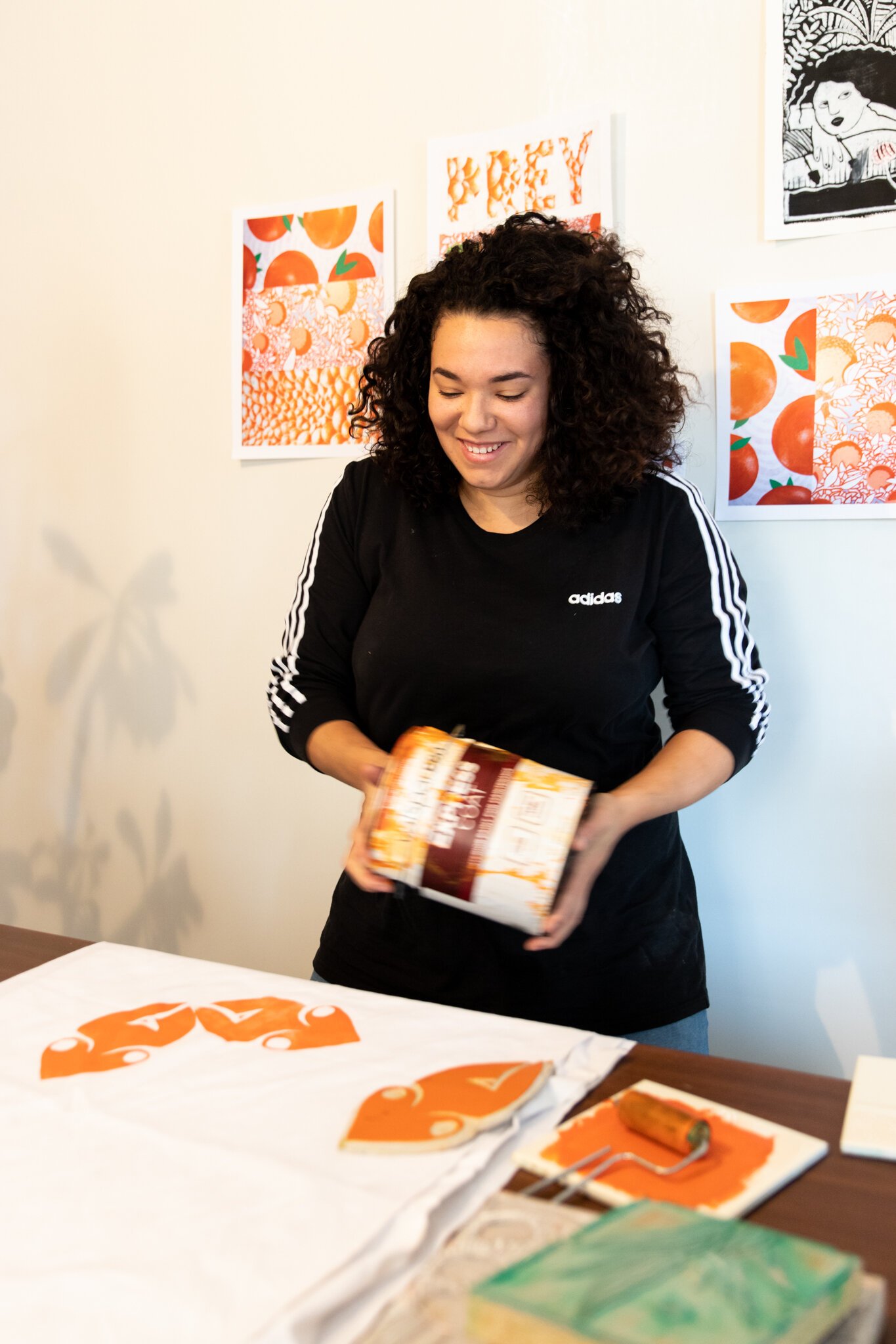 Fort Wayne Artist Lyndy Bazile preparing the paint she uses to block print.