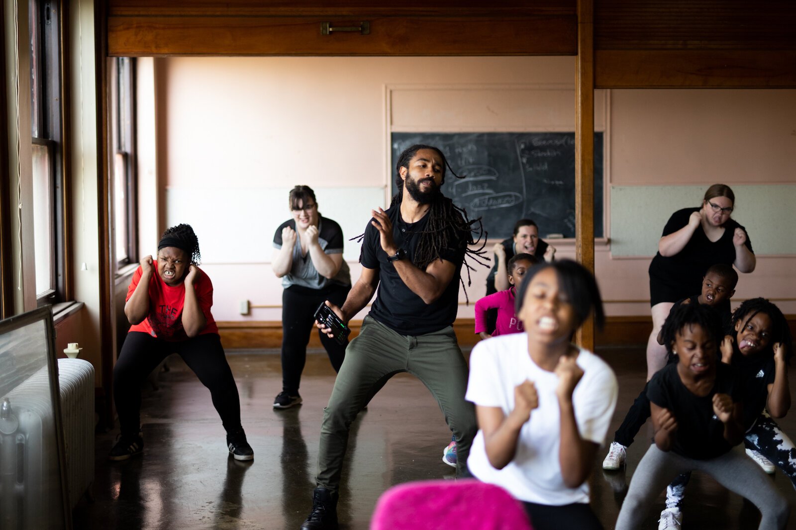 Mr. Curry, center, occasionally joins the students in a step routine during practice.