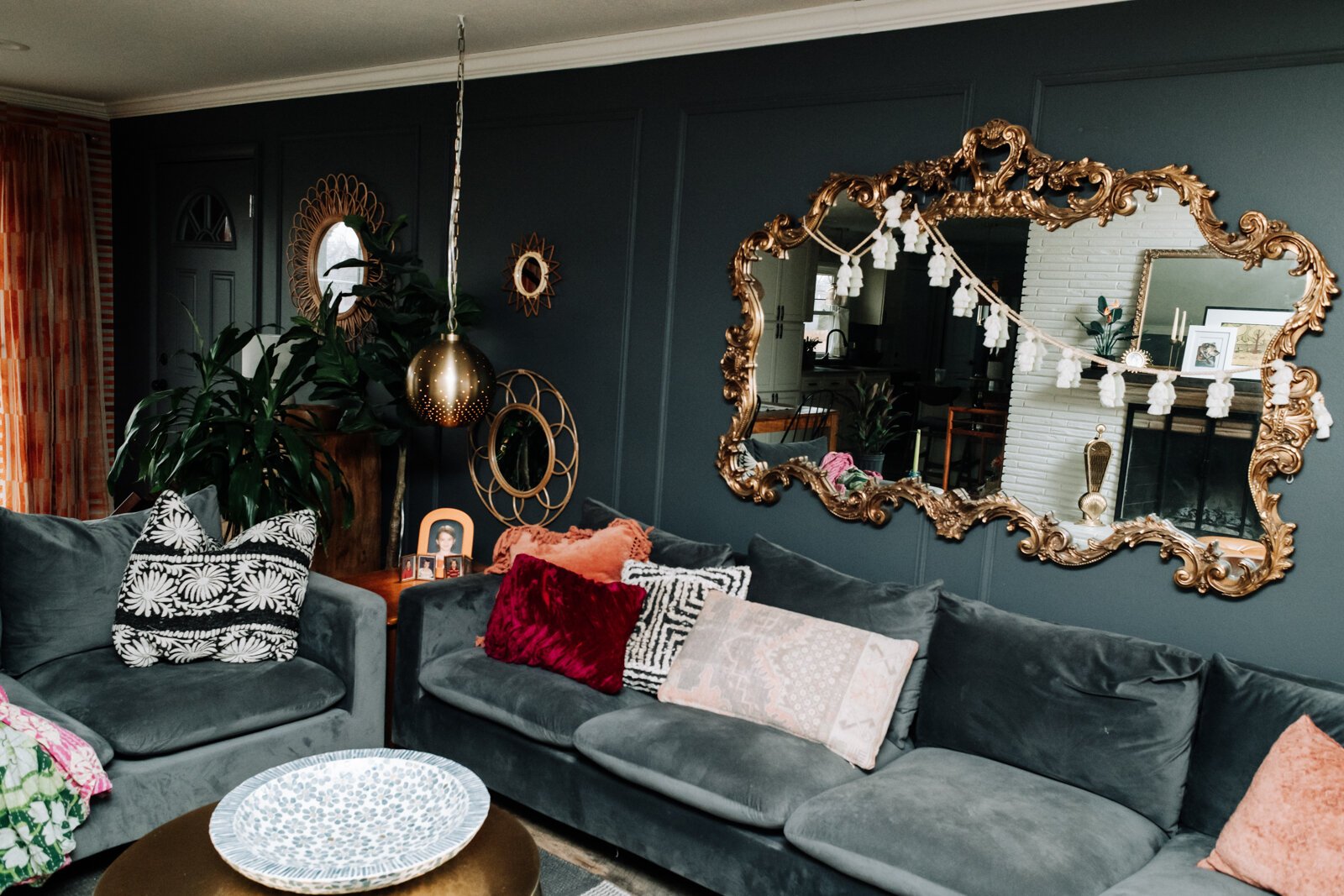 Plants, secondhand pieces, mirrors, texture, and local art define the style aesthetic of Alexa Keefe's living room.