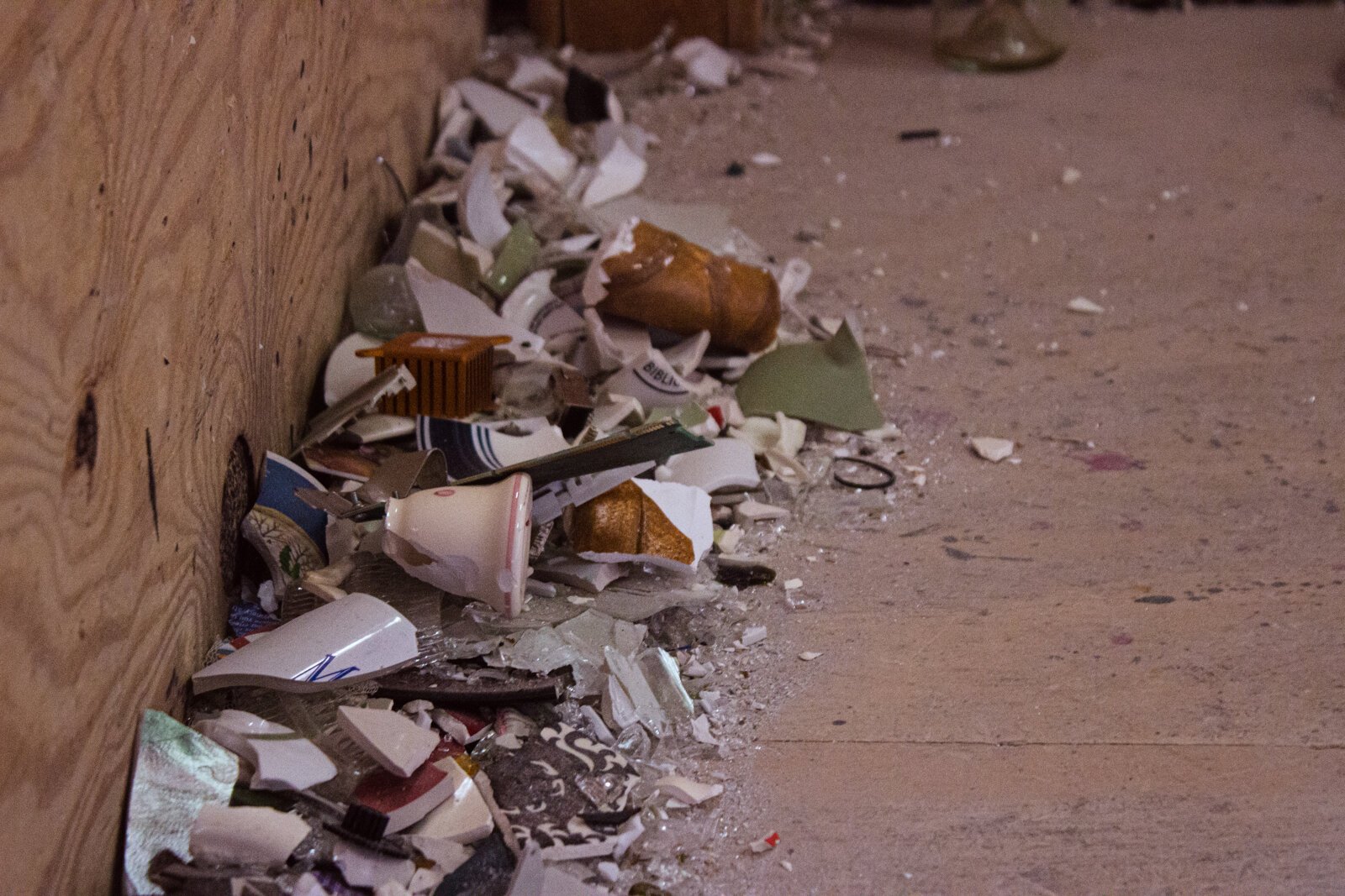 Broken glass on the floor of a rage room at All the Rage.