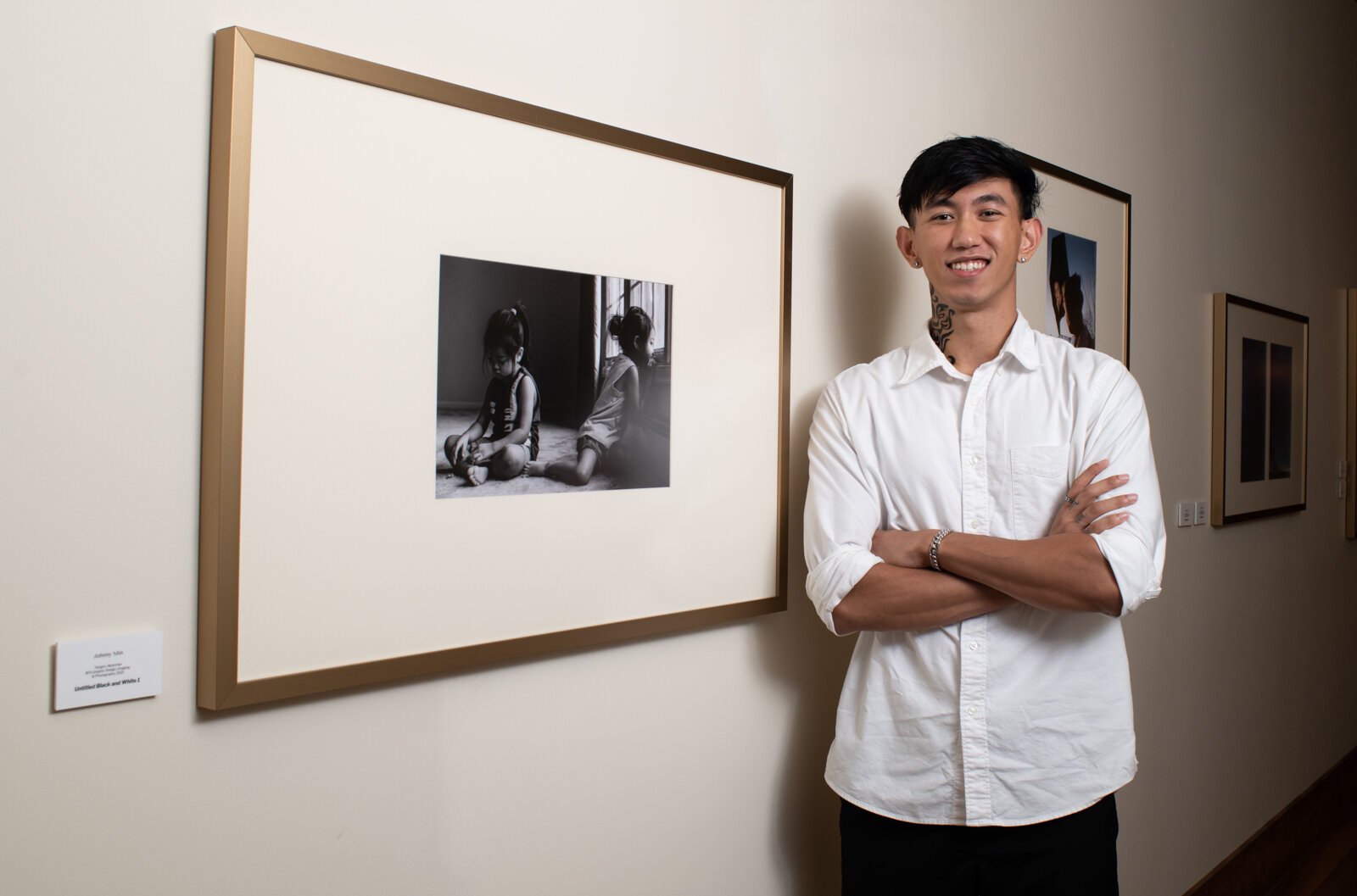 PFW graduate and artist Johnny Min in the new revolving gallery featuring work from Purdue Fort Wayne students, alumni and faculty at The Bradley.