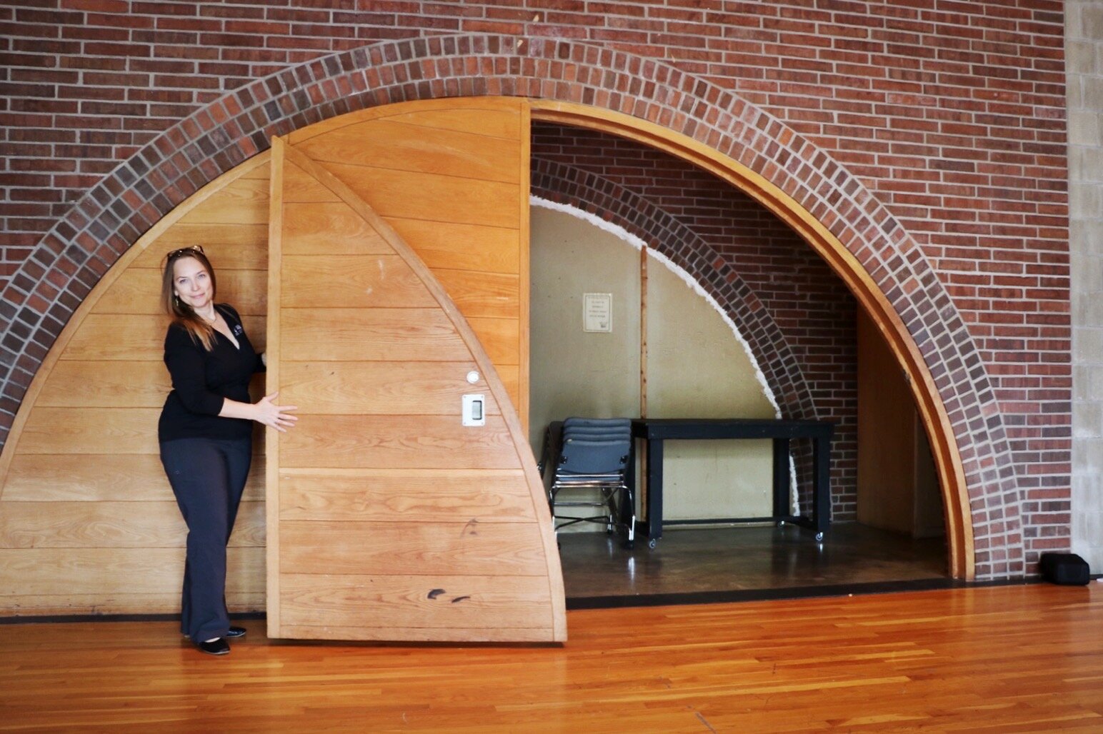 This unique door, inside one of the practice/rehearsal spaces at the Arts United Center, is filled with gravel for weight, and it fits perfectly inside one of the brick archways.