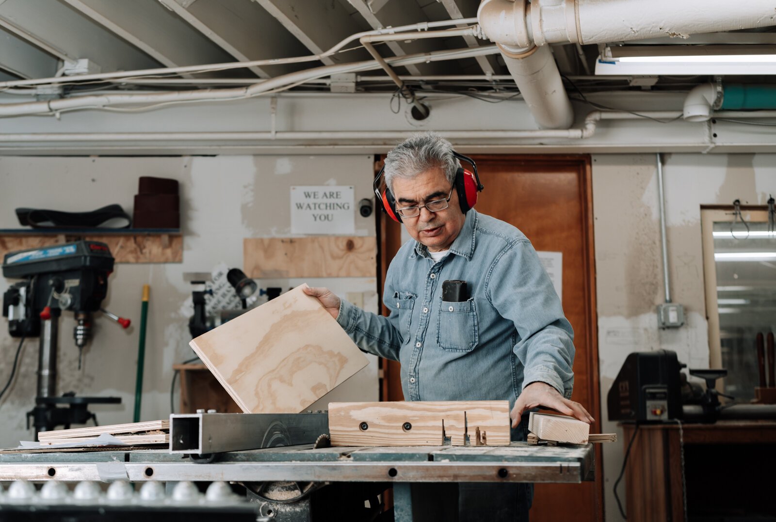 Robert Rhee works on making a tool organizer while at The Build Guild, 1025 Goshen Ave.