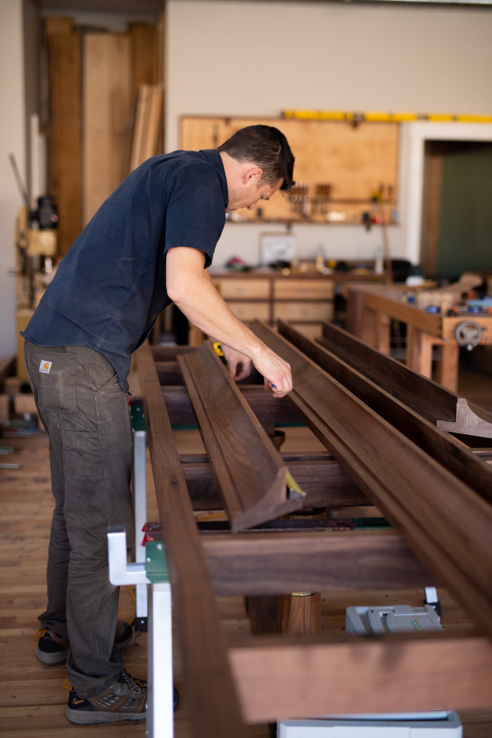 Nicholas Cramer, Owner of Big Tooth Co., is making furniture, like conference tables, for the future Electric Works campus, using felled trees from the construction site.