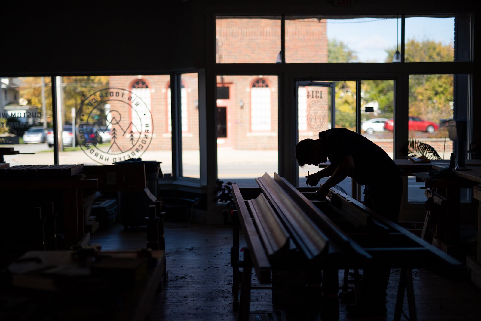 Nicholas Cramer, Owner of Big Tooth Co., is making furniture, like conference tables, for the future Electric Works campus, using felled trees from the construction site.