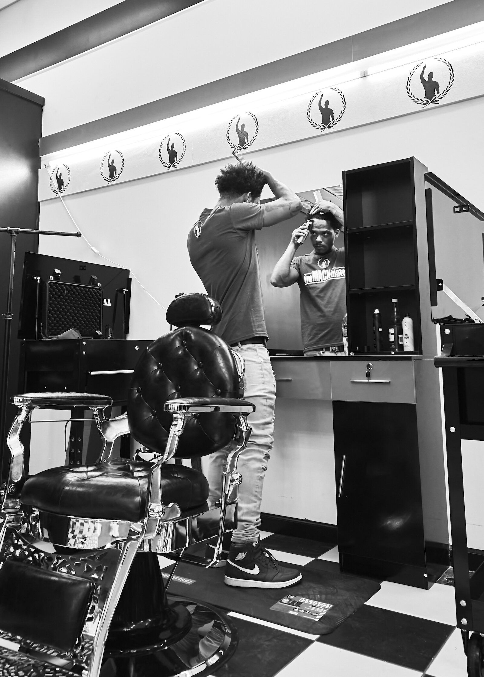 Mark Vachon trims his own hair at the new iMack Barber Lounge.