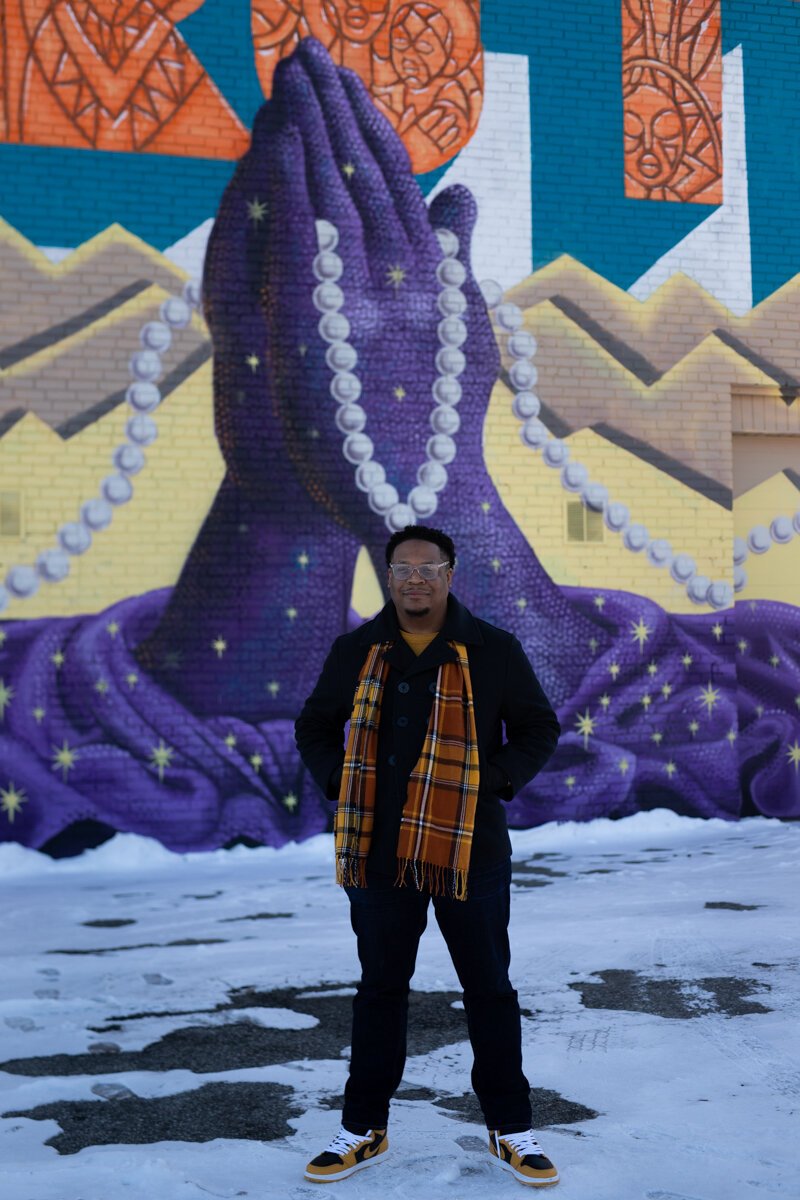 Theopolis Smith III stands in front of the Truth Mural, which he made in collaboration with three other Fort Wayne artists.