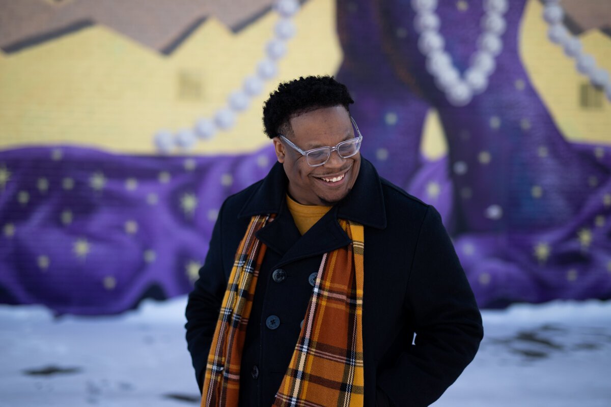 Theopolis Smith III stands in front of the Truth Mural, which he made in collaboration with three other Fort Wayne artists.