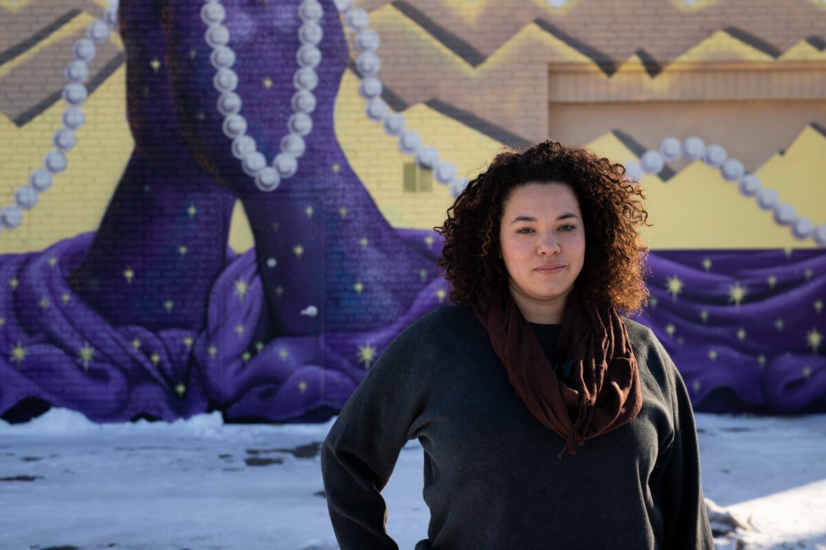 Lyndy Bazile stands in front of the Truth Mural, which she made in collaboration with three other Fort Wayne artists.