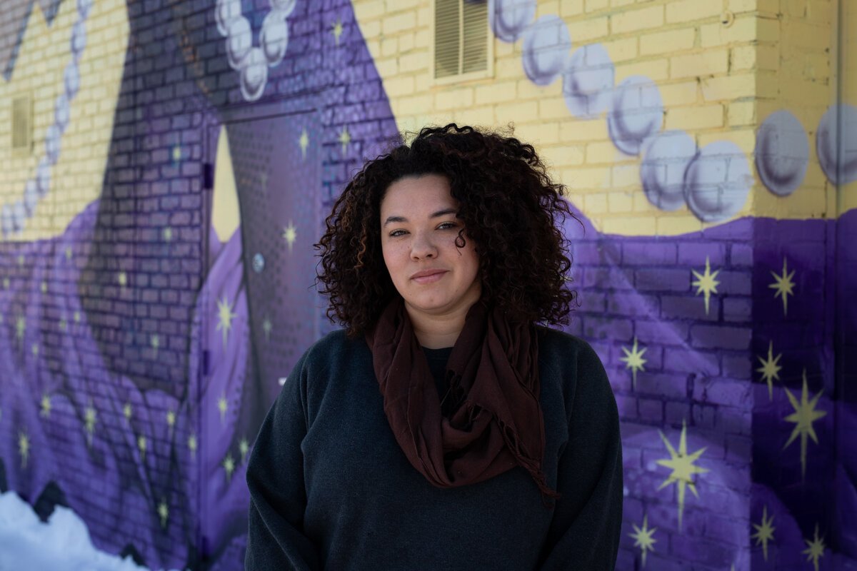 Lyndy Bazile stands in front of the Truth Mural, which she made in collaboration with three other Fort Wayne artists.