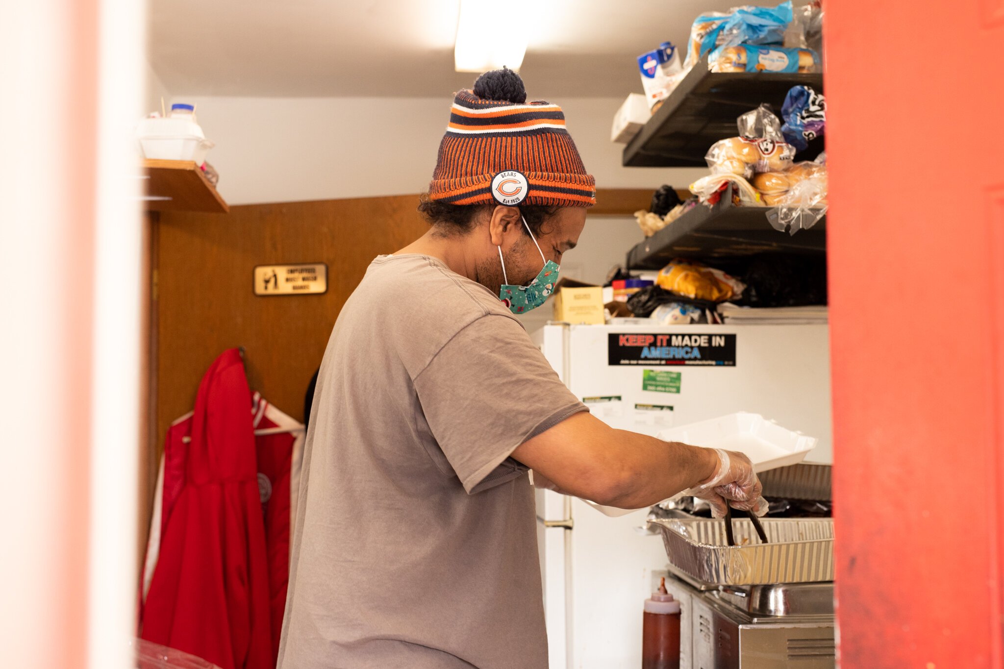 Ty Simmons of the Human Agricultural Co-op serves food at the Curbside BBQs.