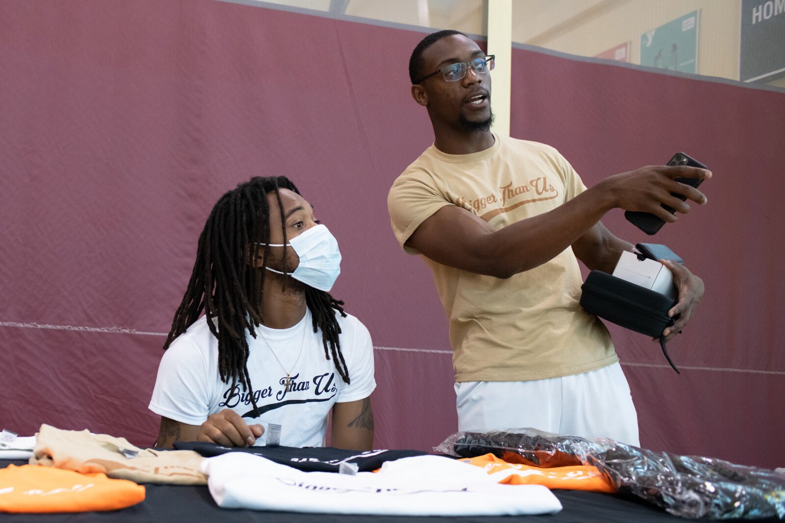 From right: CEO of Bigger Than Us Jerrell Holman, right, and Markiston Williams, CFO & Secretary, work together before the start of the Book Bag Giveaway at Renaissance Pointe YMCA, 2323 Bowser Ave.