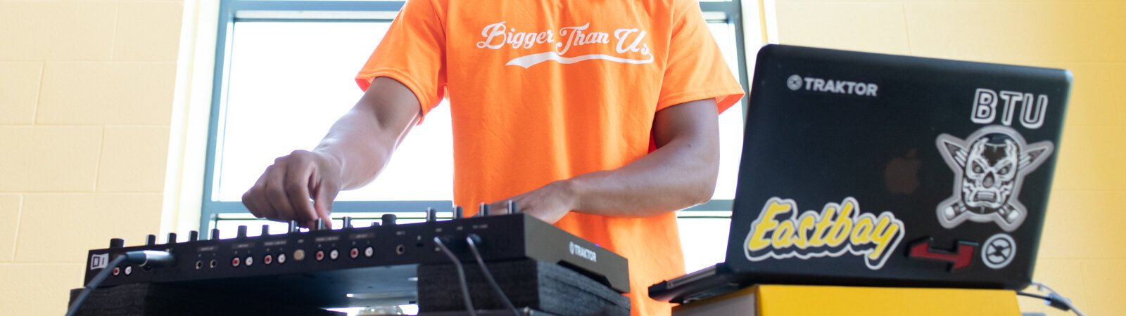 Tyler Whitfield, Vice President of Bigger Than Us, DJs during a Book Bag Giveaway at Renaissance Pointe YMCA, 2323 Bowser Ave.