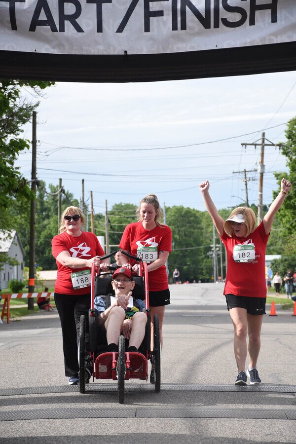 Captain Mike cross the finish line with his team of Angels.