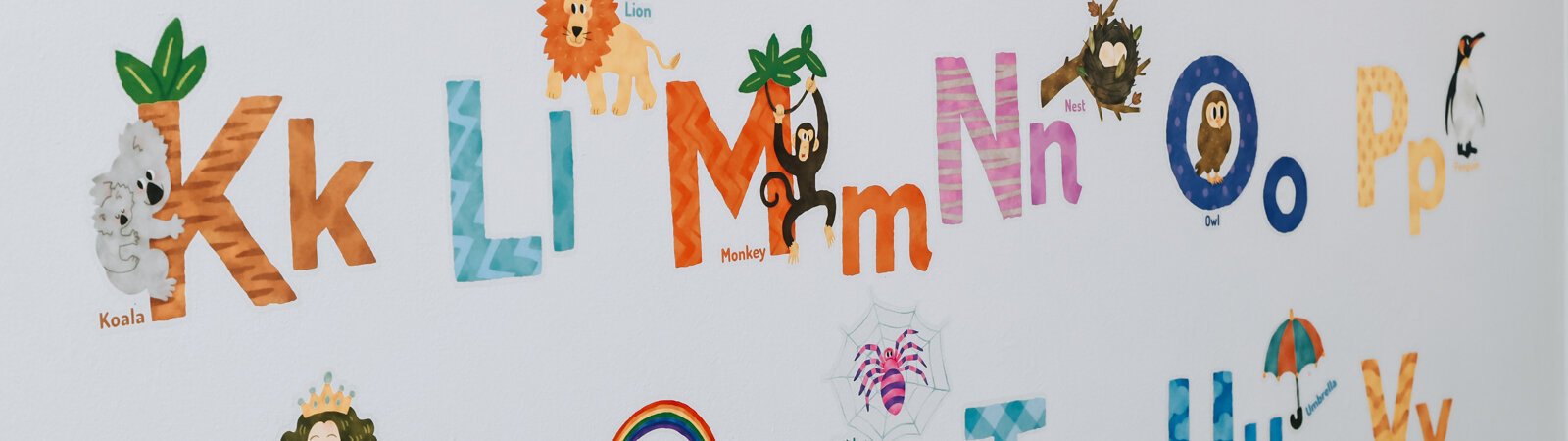 A letters learning activity on the wall for the children at Deondra Steward's home-based daycare service Unique Cherubs.