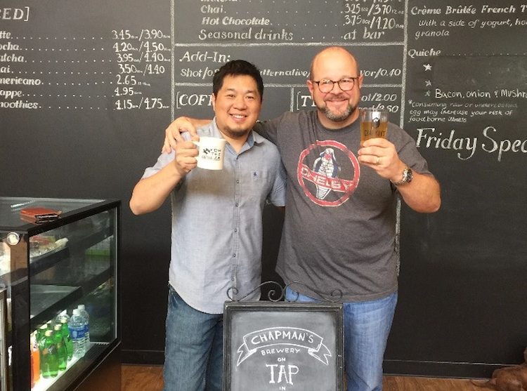Sean Wang, left, and Scott Fergusson, right, celebrate the Chapman's tap room in downtown Fort Wayne at Fortezza Coffee.
