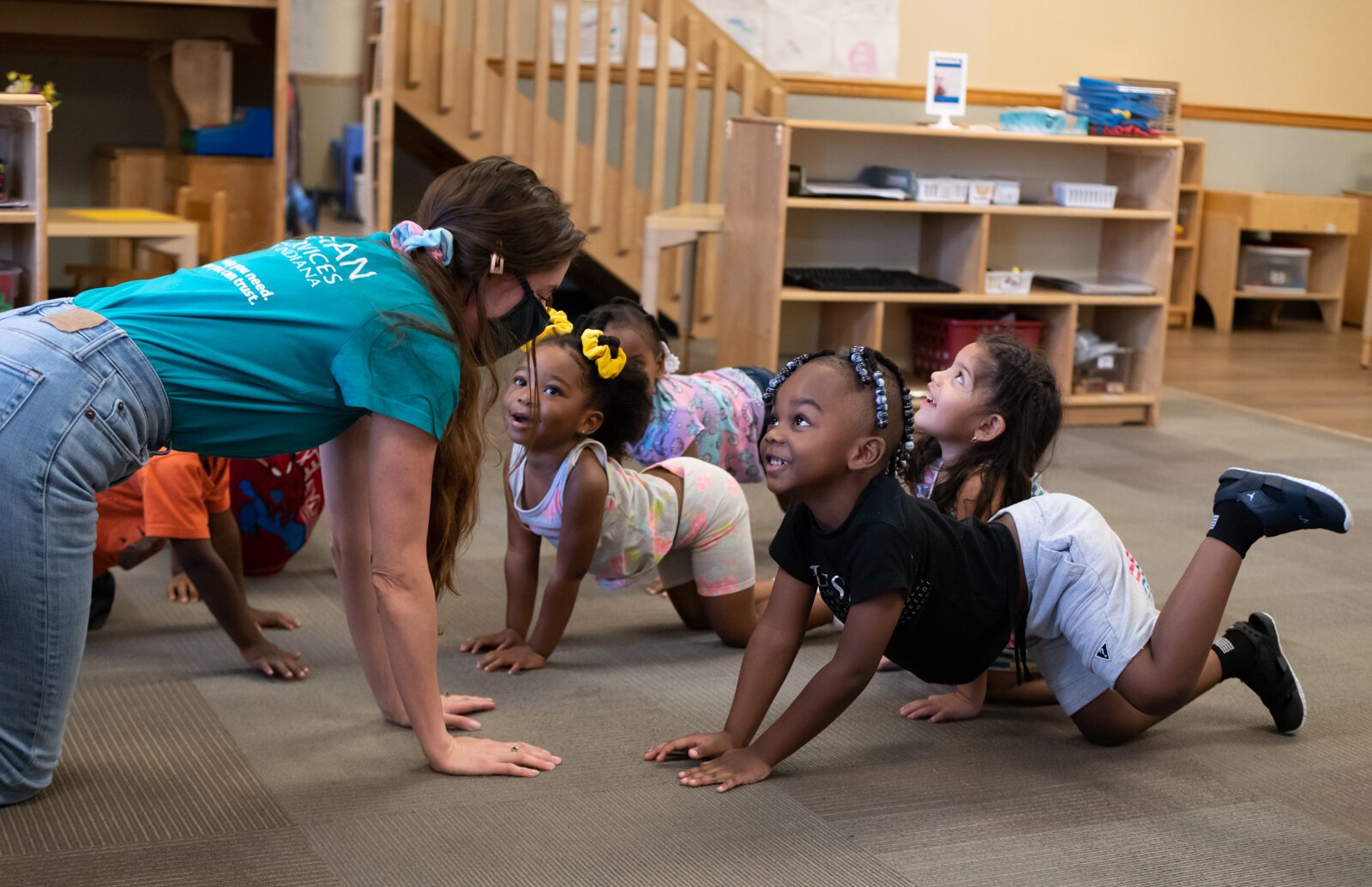 Miss Nielson stretches with children including Lelan, front, during her 3-5 year old class at Children's Village, 6613 S. Anthony.