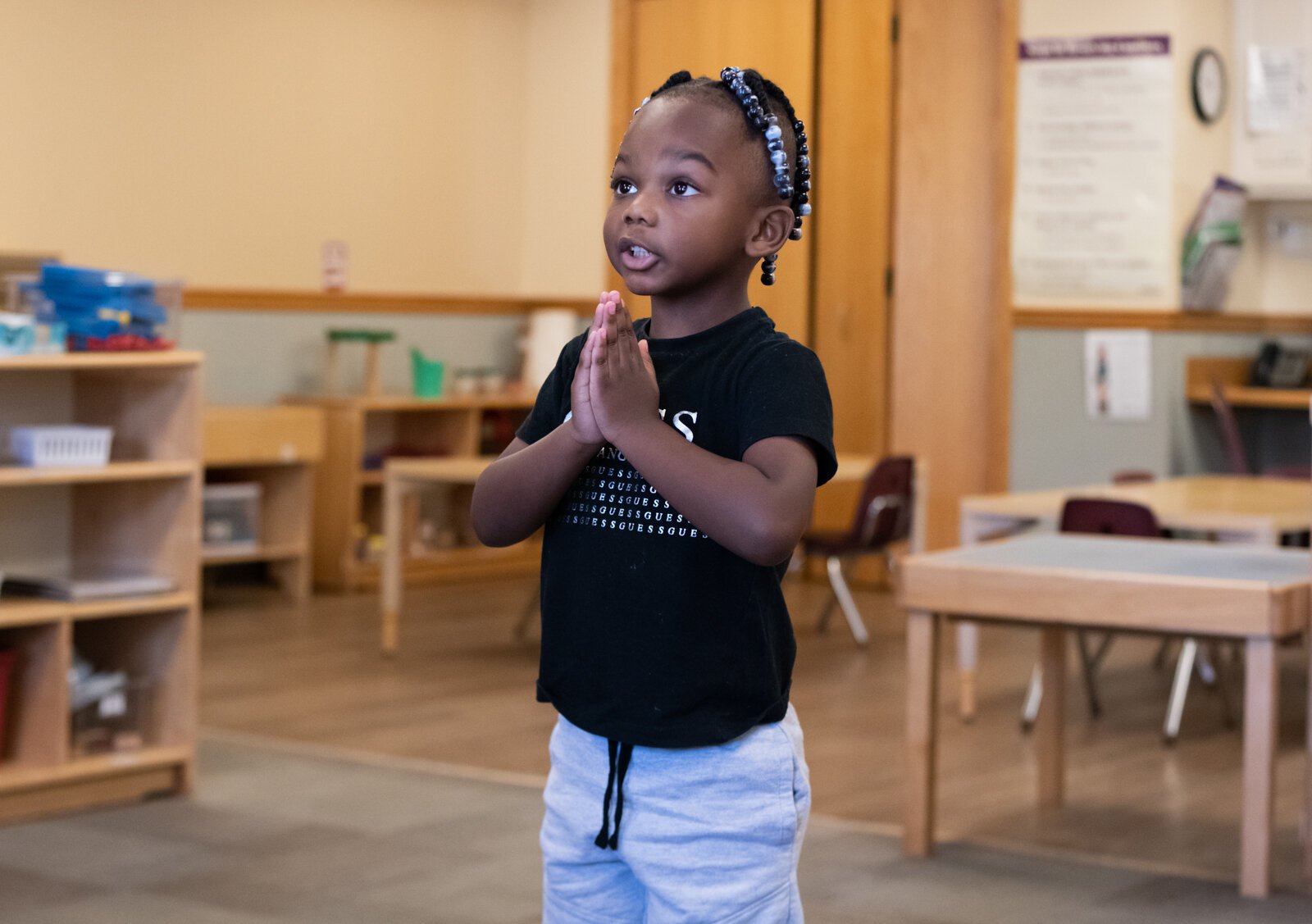 Student Lelan strikes a pose while stretching during Miss Nielson's 3-5 year old class at Children's Village, 6613 S. Anthony.