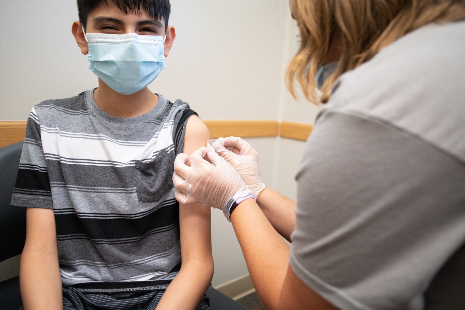 Anthony gets a school vaccination from Staci Kaczmarek at Super Shot, 1515 Hobson Road.