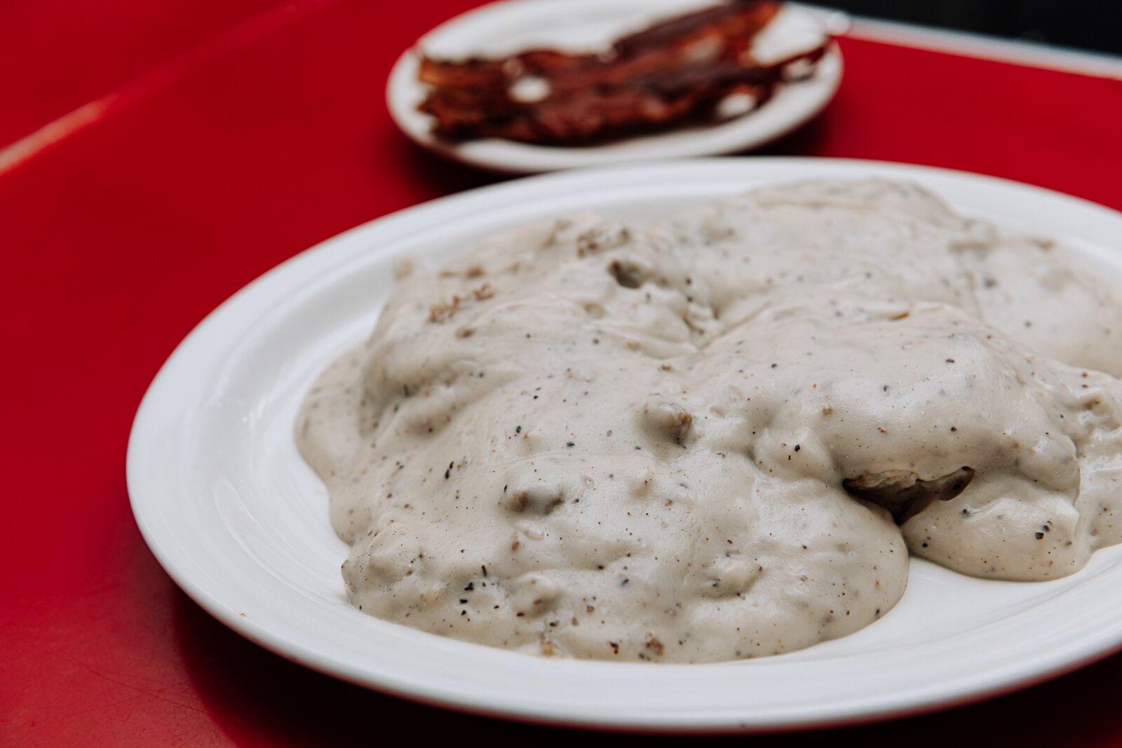 The country sausage gravy and biscuits with a side of bacon at Cindy's Diner, 230 W. Berry St.