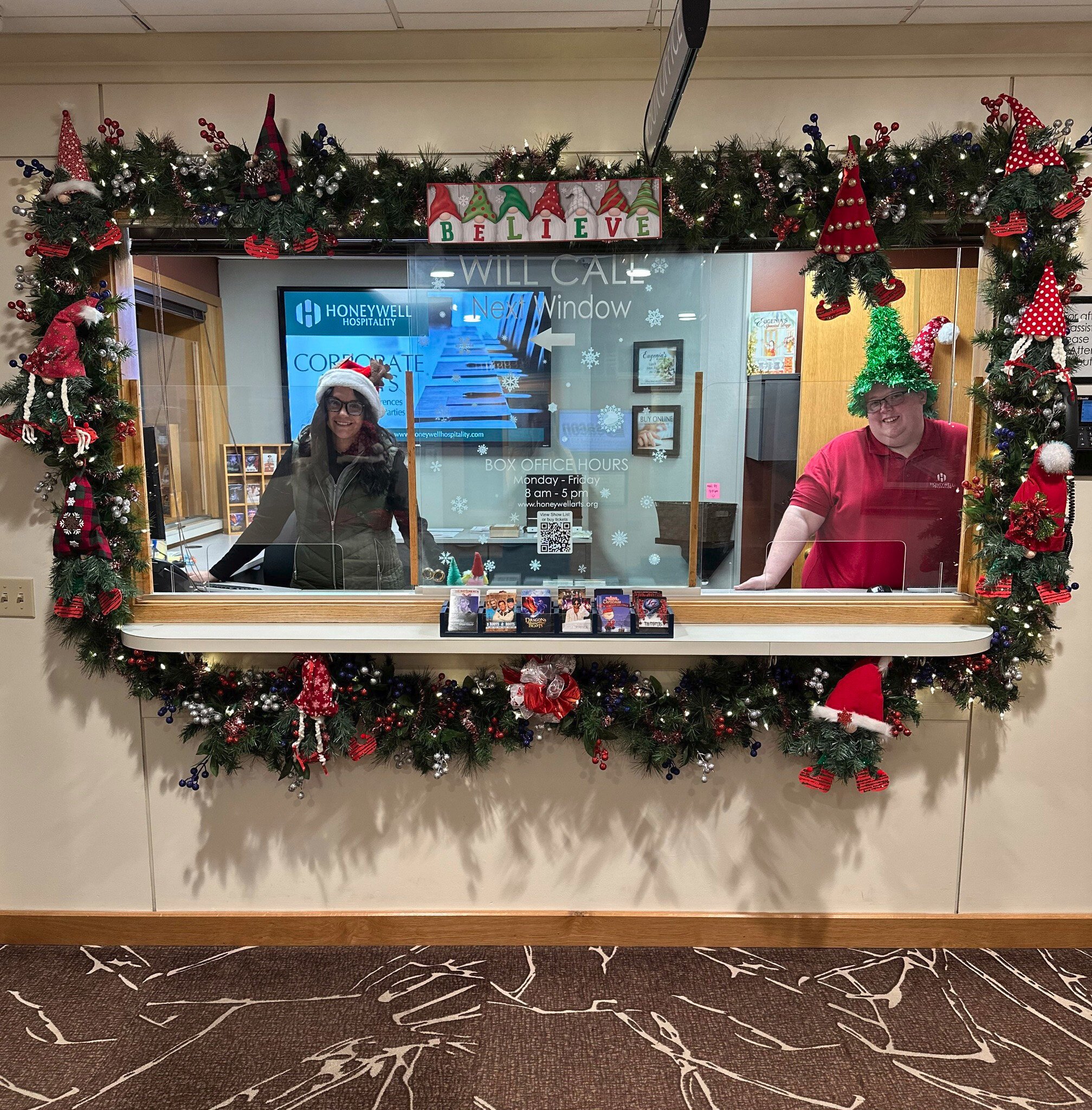 Shelby McLaughlin, Guest Relations Associate, and Cody Lee, Guest Relations Supervisor, celebrate the season with a decorated box office and festive hats.