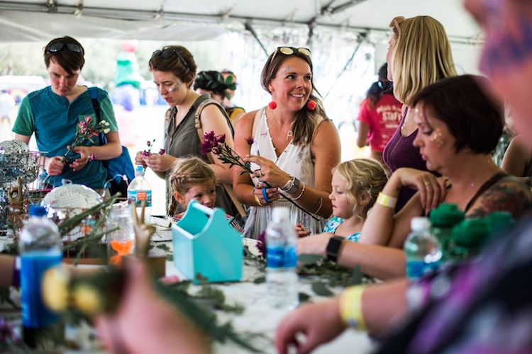 Festival goers have the opportunity to make crafts like flower crowns.